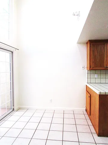 a kitchen with granite countertop a sink a stove and refrigerator