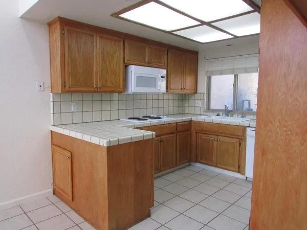 a kitchen with a sink cabinets and appliances