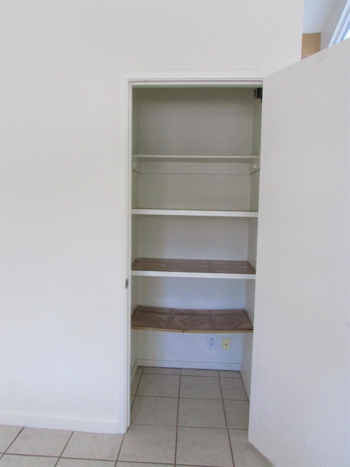 1855 Scenic Drive, Unit F Modesto, CA 95355 - Photo 27 of 52 a view of walk in closet with empty racks