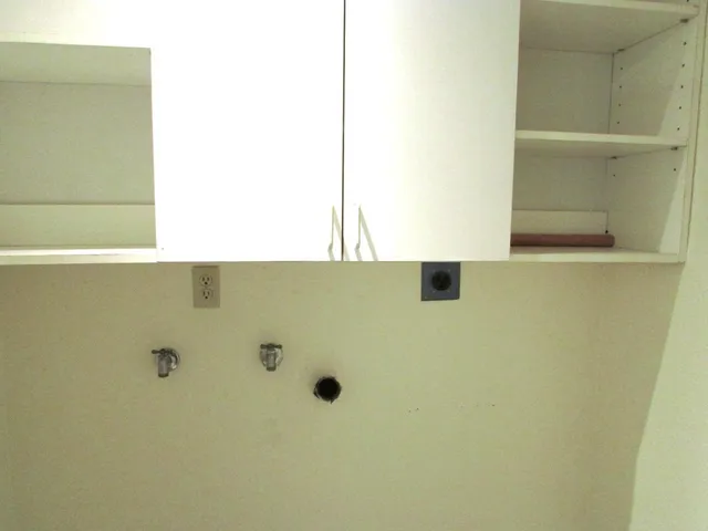 an empty room with a ceiling fan and a window