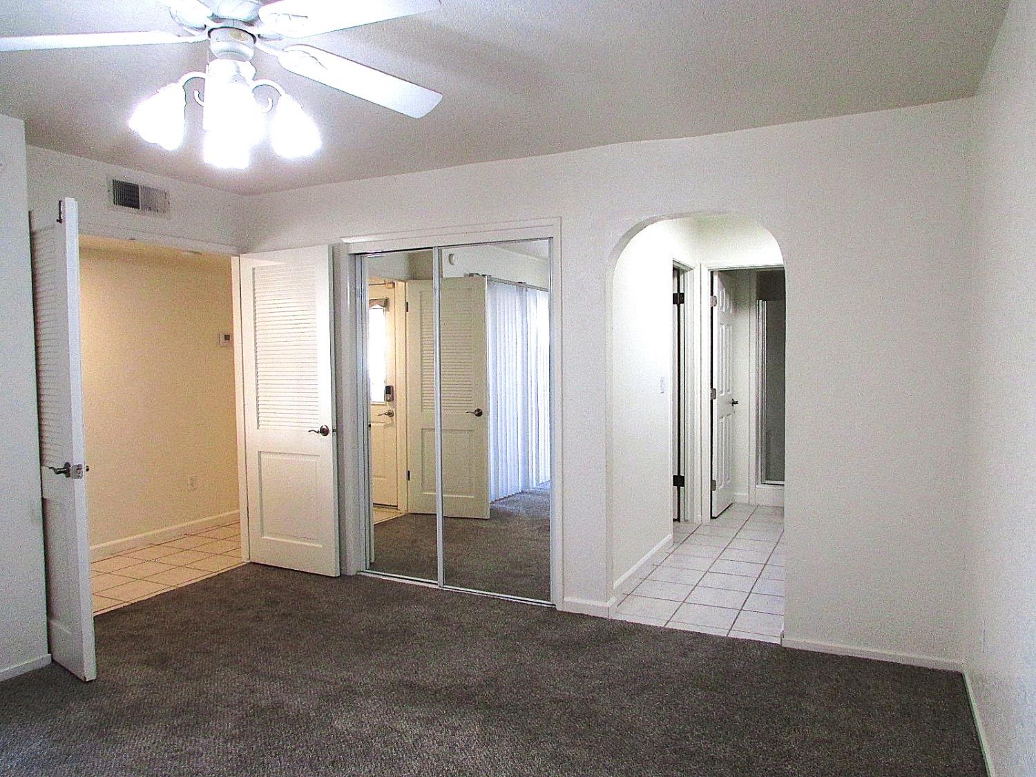 1855 Scenic Drive, Unit F Modesto, CA 95355 - Photo 39 of 52 wooden floor in an empty room with a mirror