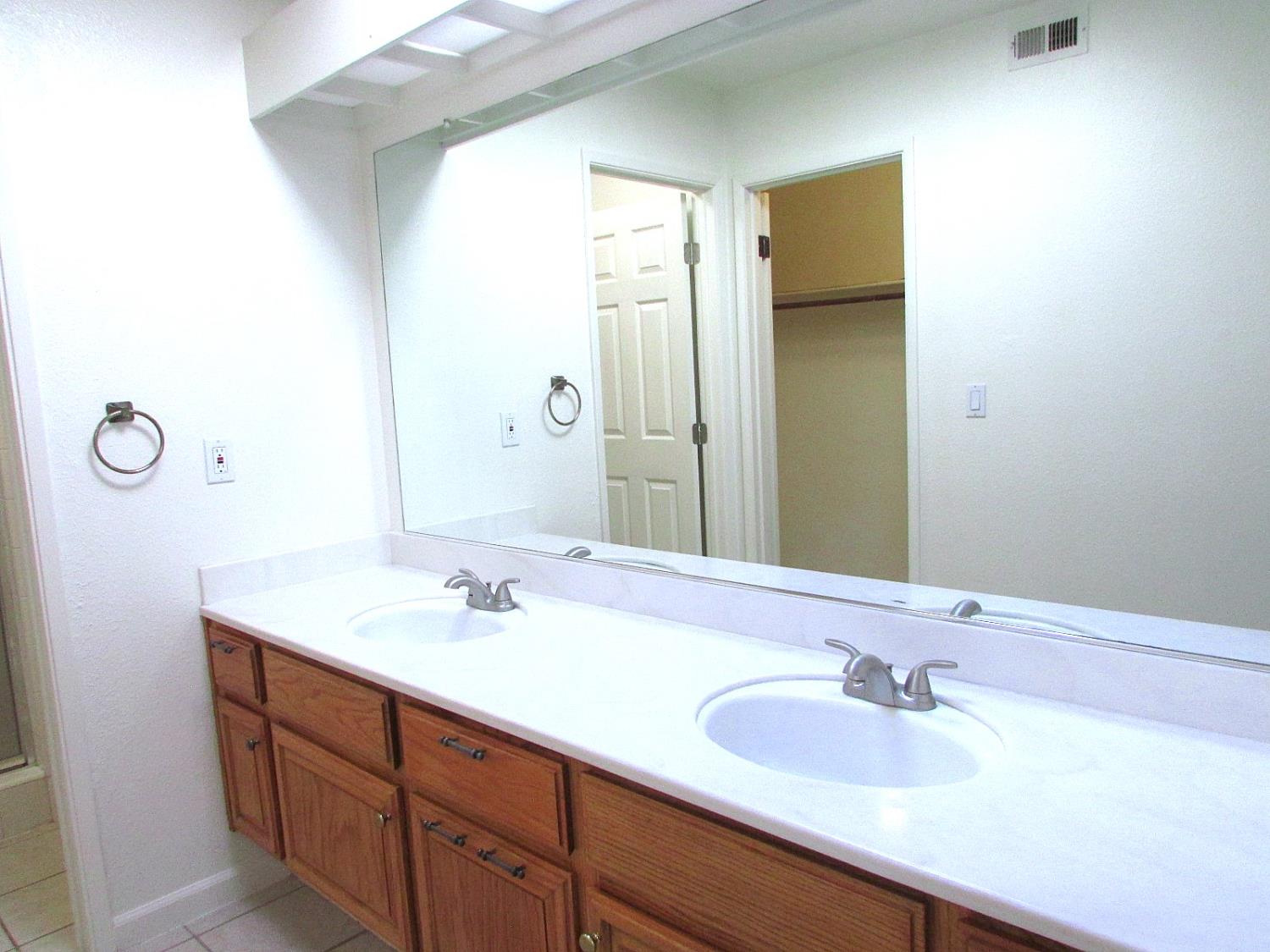 1855 Scenic Drive, Unit F Modesto, CA 95355 - Photo 41 of 52 a bathroom with a sink and a mirror