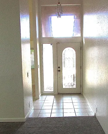 a view of a livingroom with a chandelier fan