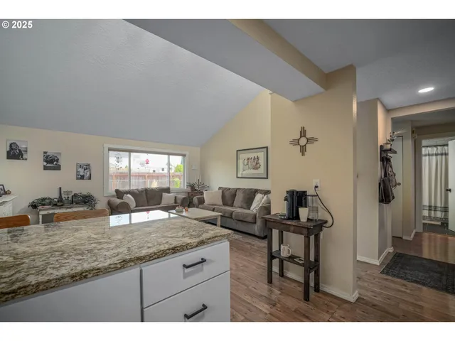 a living room with granite countertop furniture and wooden floor