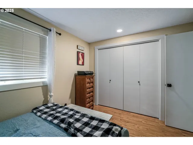 a bedroom with a bed and a window