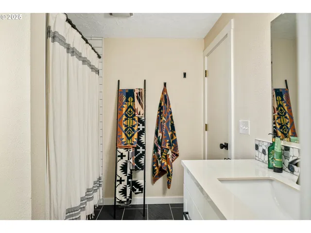 a view of a bathroom with a sink and a shower curtain