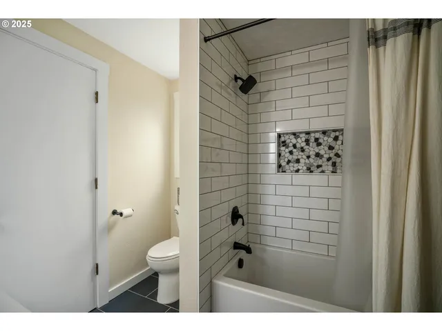 a bathroom with a shower toilet and a sink