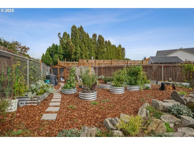 a view of a backyard with garden and patio