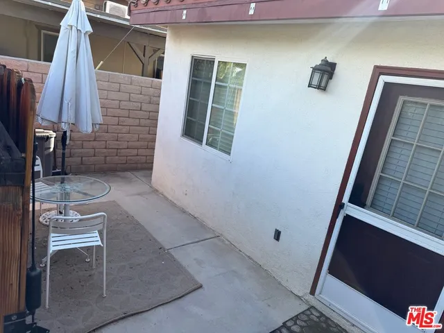 a view of backyard with a patio