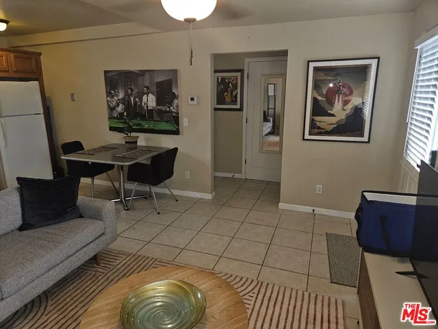 a living room with furniture and a painting on the wall