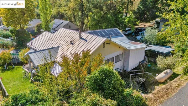 a view of a house with a yard and potted plants
