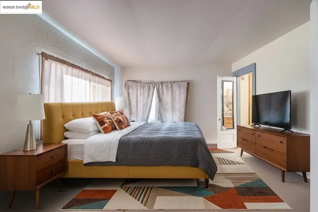 a bedroom with a bed and flat screen tv