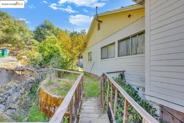a view of balcony with wooden floor and fence