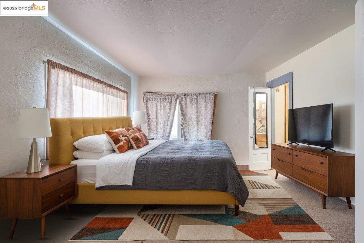 832 Shaws Flat Road Sonora, CA 95370 - Photo 9 of 25 a bedroom with a bed and flat screen tv