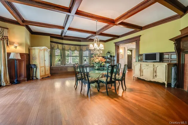 a view of a kitchen with wooden floor and electronic appliances