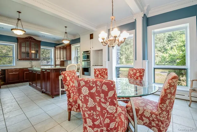 a open kitchen with granite countertop a stove and a white cabinets