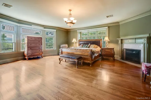 a spacious bedroom with a bed and a chandelier