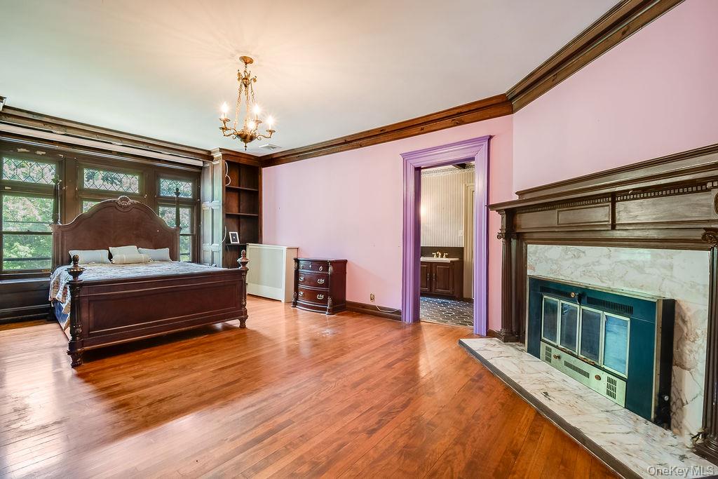 24 Jill Road Highland Mills, NY 10930 - Photo 26 of 43 a bedroom with furniture and a fireplace