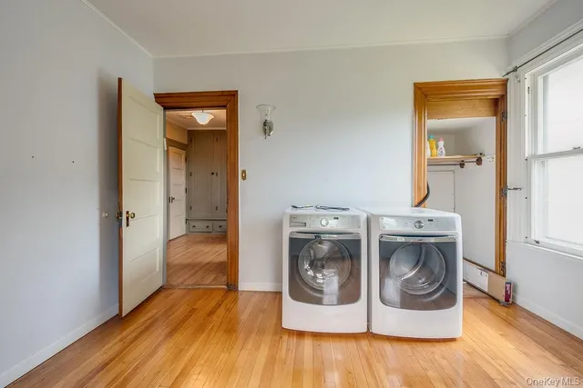 a utility room with wooden floor and sink