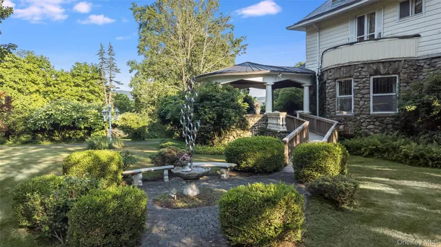 a view of a chair and table in backyard of the house