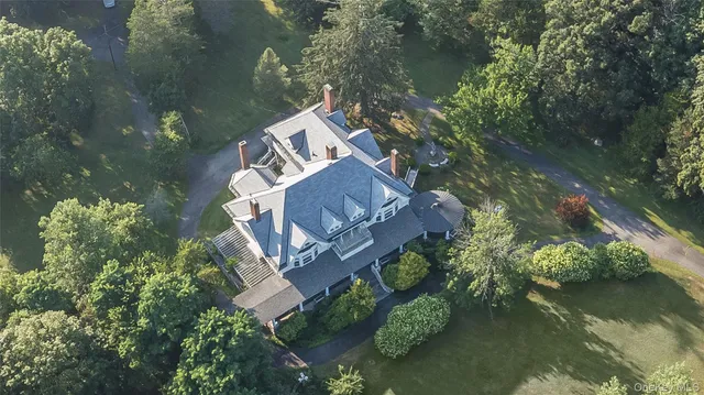 an aerial view of a house with a yard