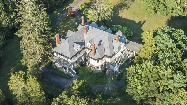 an aerial view of a house with a yard and lake view