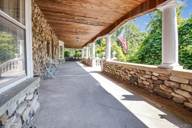 a view of a porch with wooden floor and roof