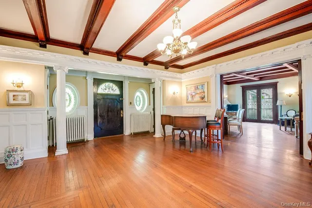 a view of a livingroom with furniture window and wooden floor