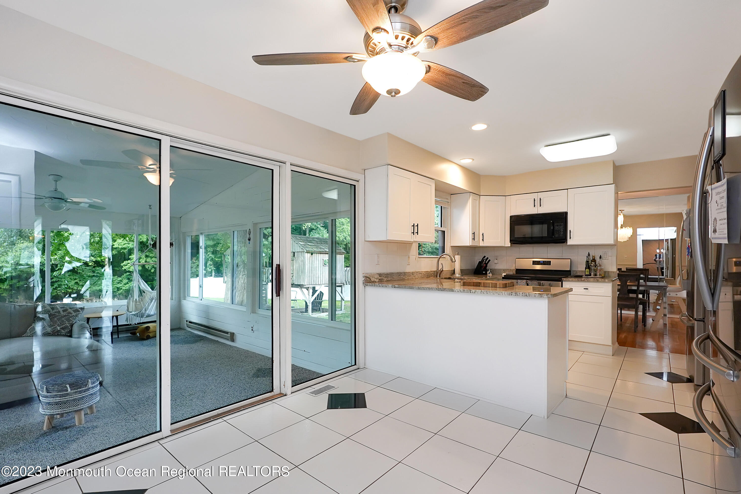 37 Prince William Road Morganville, NJ 07751 - Photo 13 of 35 a kitchen with stainless steel appliances kitchen island granite countertop a refrigerator a stove top oven a sink a dining table and chairs