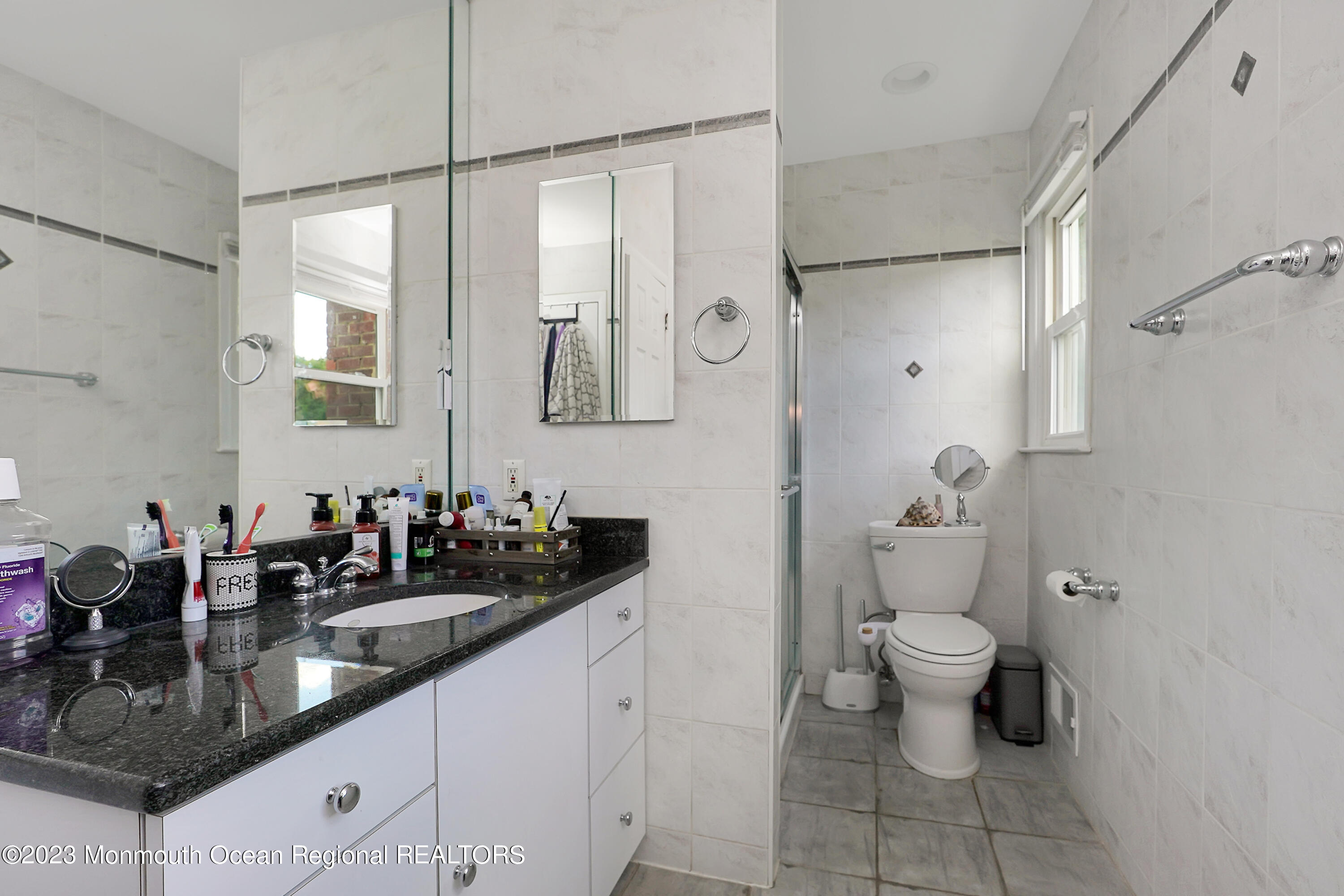 37 Prince William Road Morganville, NJ 07751 - Photo 22 of 35 a bathroom with a granite countertop sink a toilet and a mirror