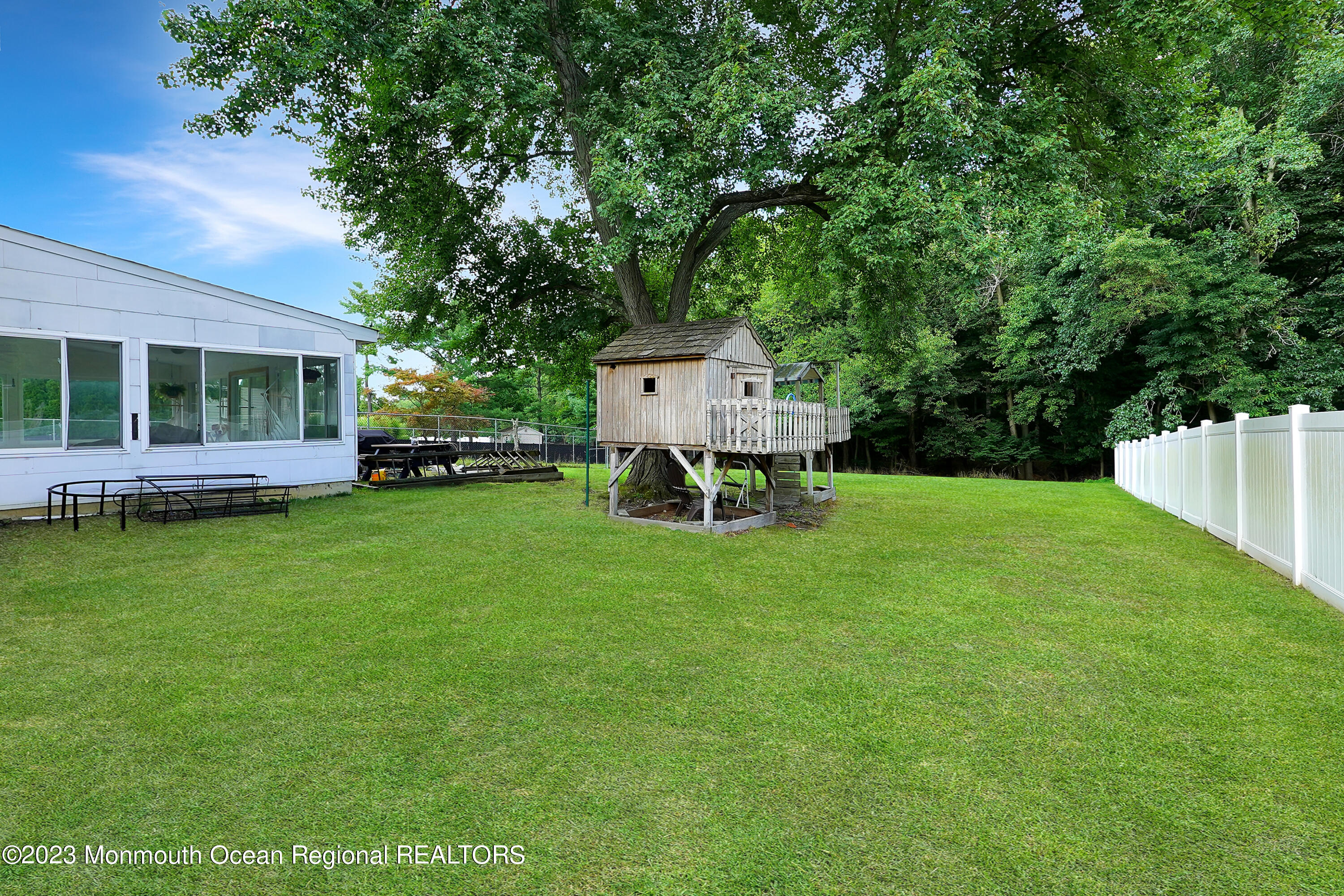 37 Prince William Road Morganville, NJ 07751 - Photo 30 of 35 a front view of a house with a garden and trees