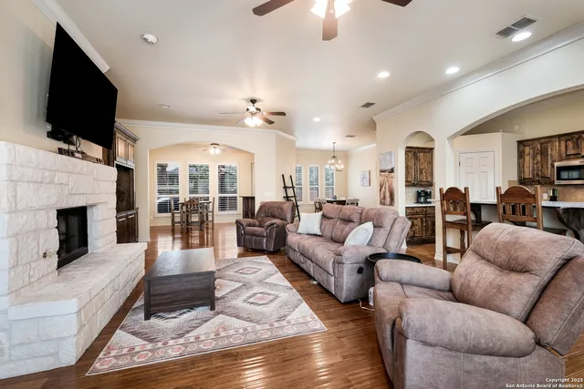 a living room with furniture fireplace and flat screen tv