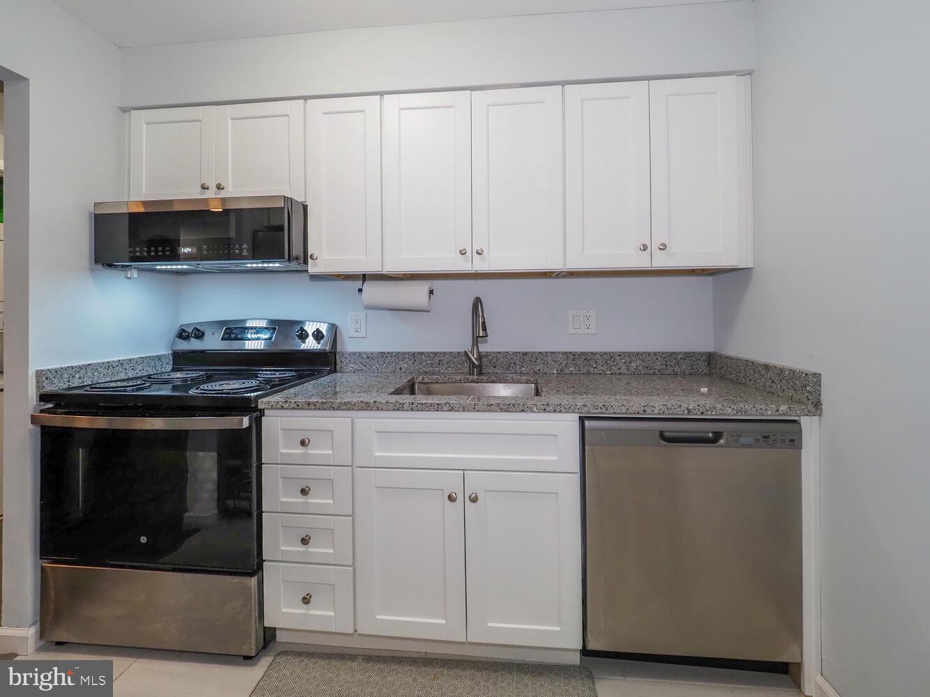612 South Charles Street, Unit R 36 Baltimore, MD 21230 - Photo 11 of 37 a kitchen with stainless steel appliances granite countertop a stove a microwave and a sink