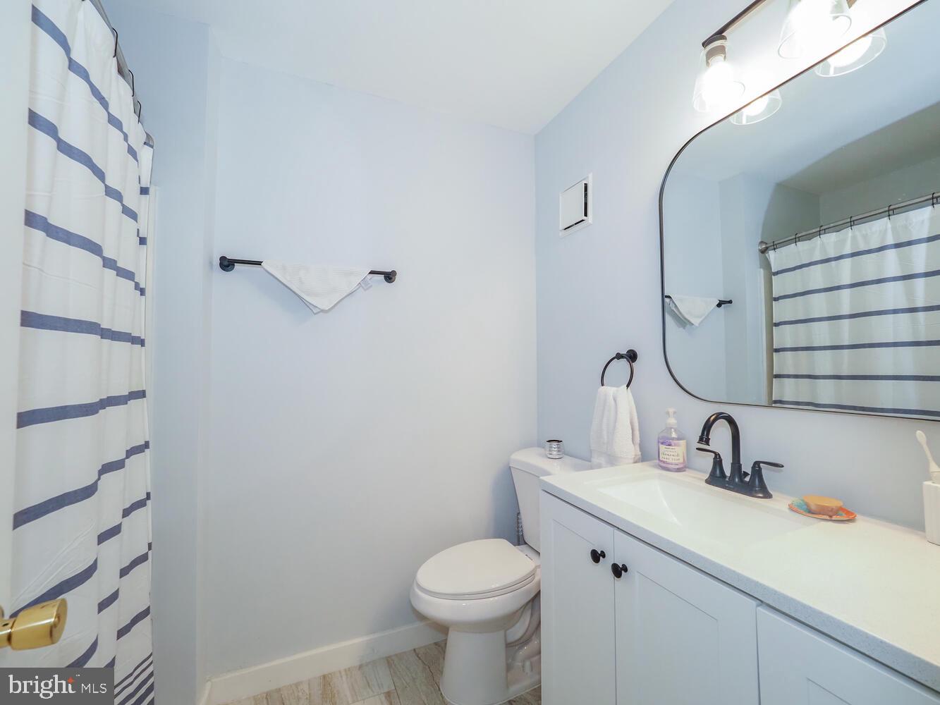 612 South Charles Street, Unit R 36 Baltimore, MD 21230 - Photo 20 of 37 a bathroom with a toilet sink and mirror