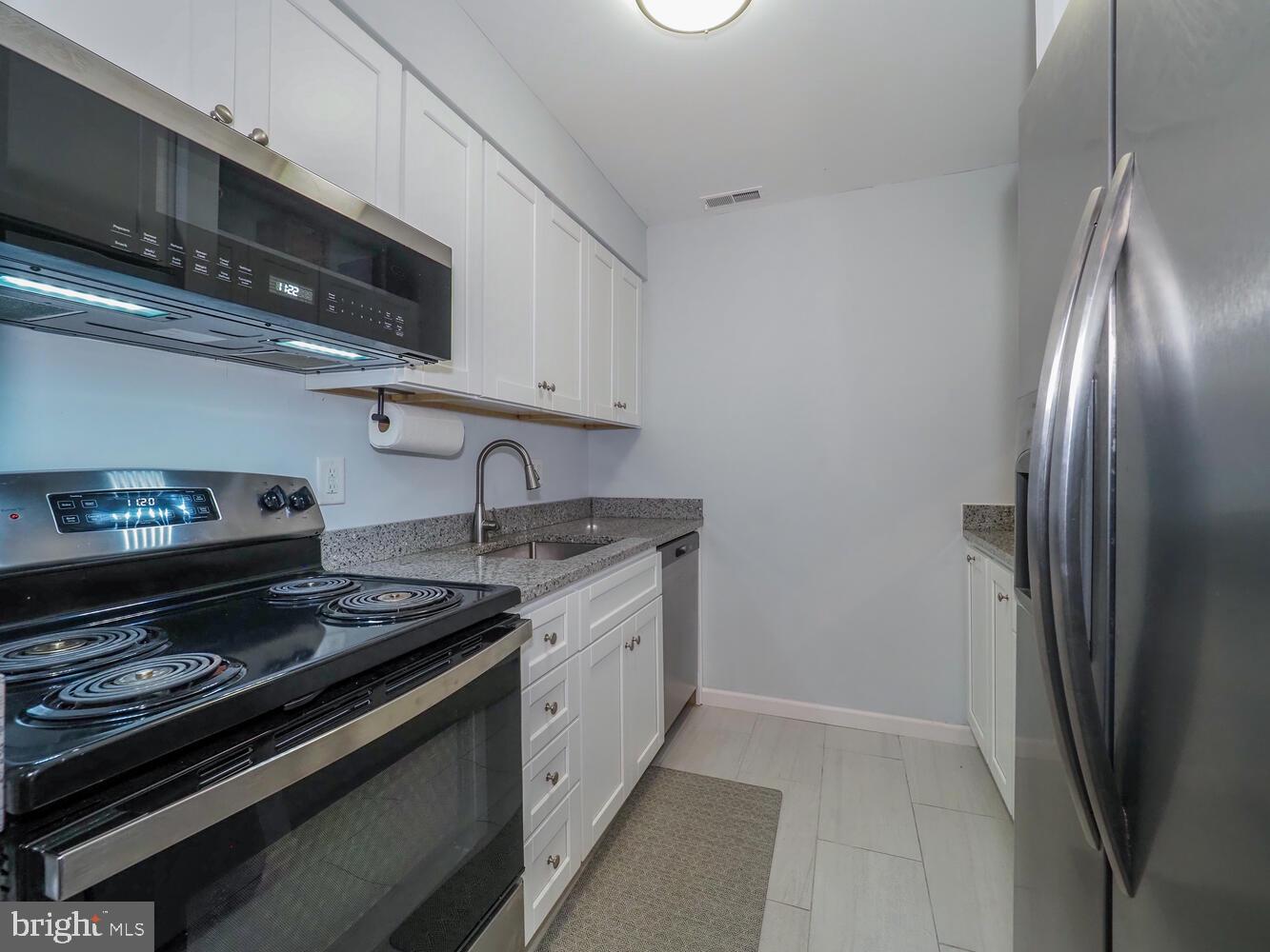 612 South Charles Street, Unit R 36 Baltimore, MD 21230 - Photo 10 of 37 a kitchen with stainless steel appliances granite countertop a stove and a refrigerator