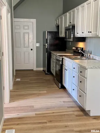 a kitchen with stainless steel appliances granite countertop a stove and a refrigerator
