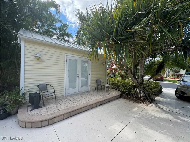 a view of a patio with table and chairs and potted plants