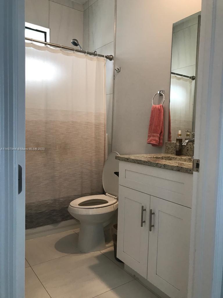 490 37th Avenue Northwest Naples, FL 34120 - Photo 12 of 16 a bathroom with a sink a toilet and shower