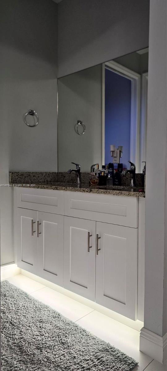490 37th Avenue Northwest Naples, FL 34120 - Photo 14 of 16 a bathroom with a sink and a mirror