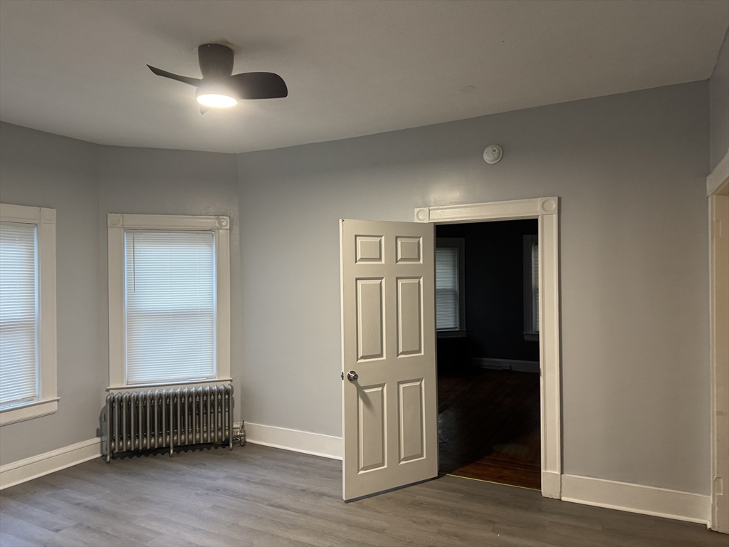 44 Belmont Avenue Springfield, MA 01108 - Photo 1 of 7 an empty room with wooden floor and windows