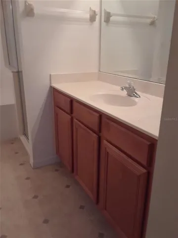 a bathroom with a shower and a sink