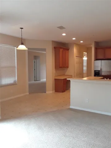 a view of a kitchen with kitchen island and stainless steel appliances