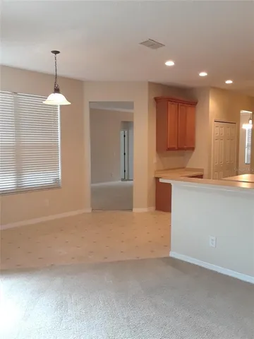 a kitchen with kitchen island white cabinets and stainless steel appliances
