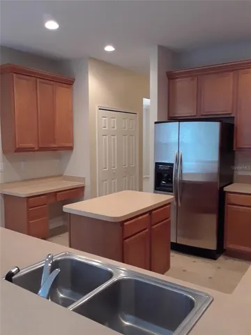 a kitchen that has a sink and a stove in it