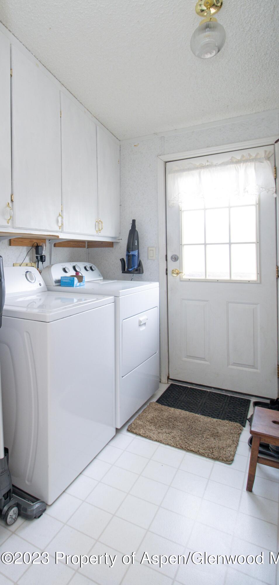 2345 County Road 306 Parachute, CO 81635 - Photo 14 of 29 a room with a washing machine and cabinets