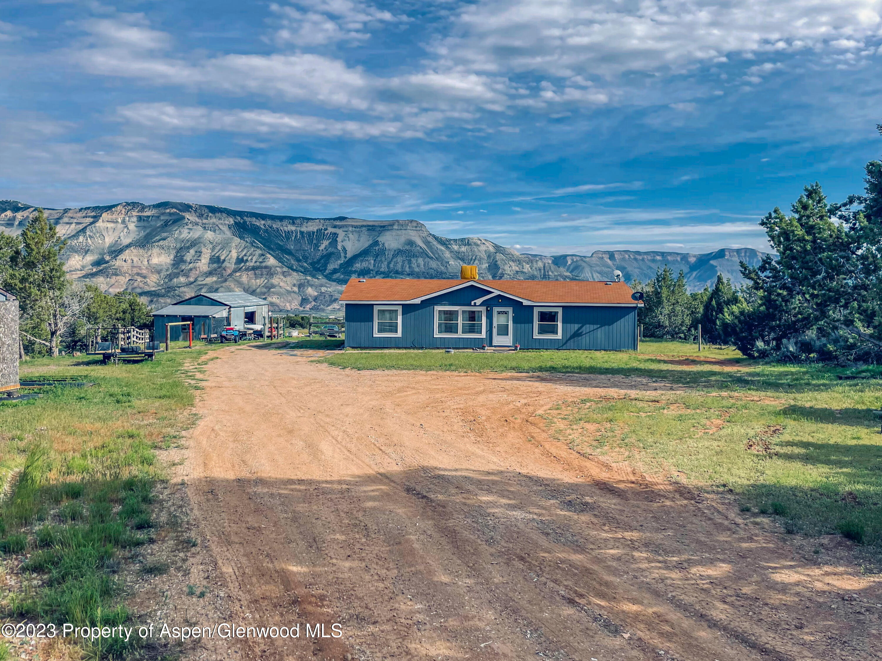 2345 County Road 306 Parachute, CO 81635 - Photo 2 of 29 a house with swimming pool in front of it