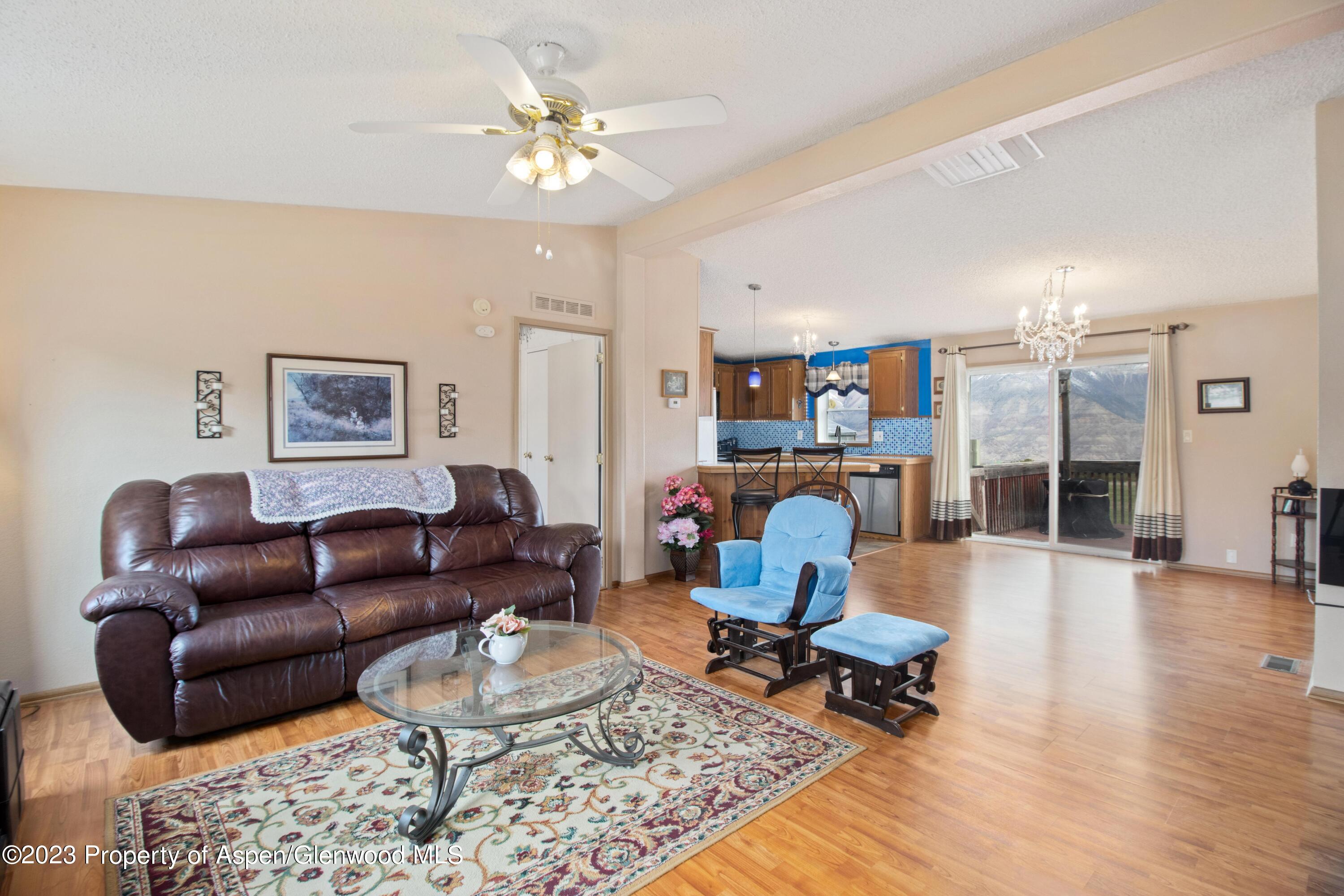 2345 County Road 306 Parachute, CO 81635 - Photo 3 of 29 a living room with furniture a rug and kitchen view