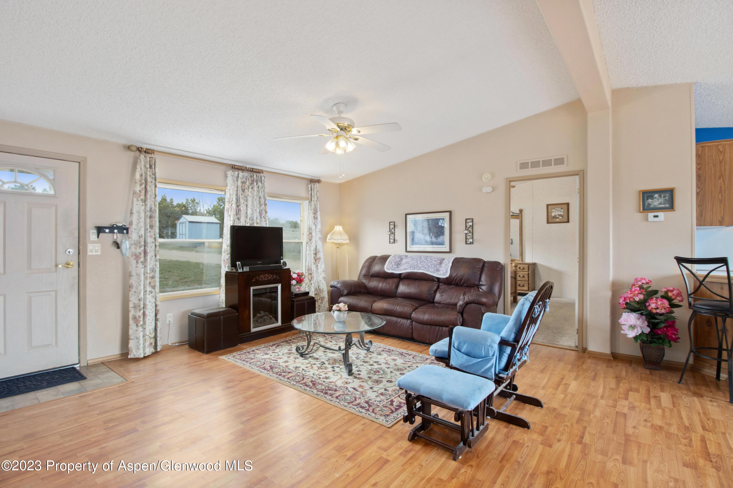 2345 County Road 306 Parachute, CO 81635 - Photo 6 of 29 a living room with furniture and a flat screen tv