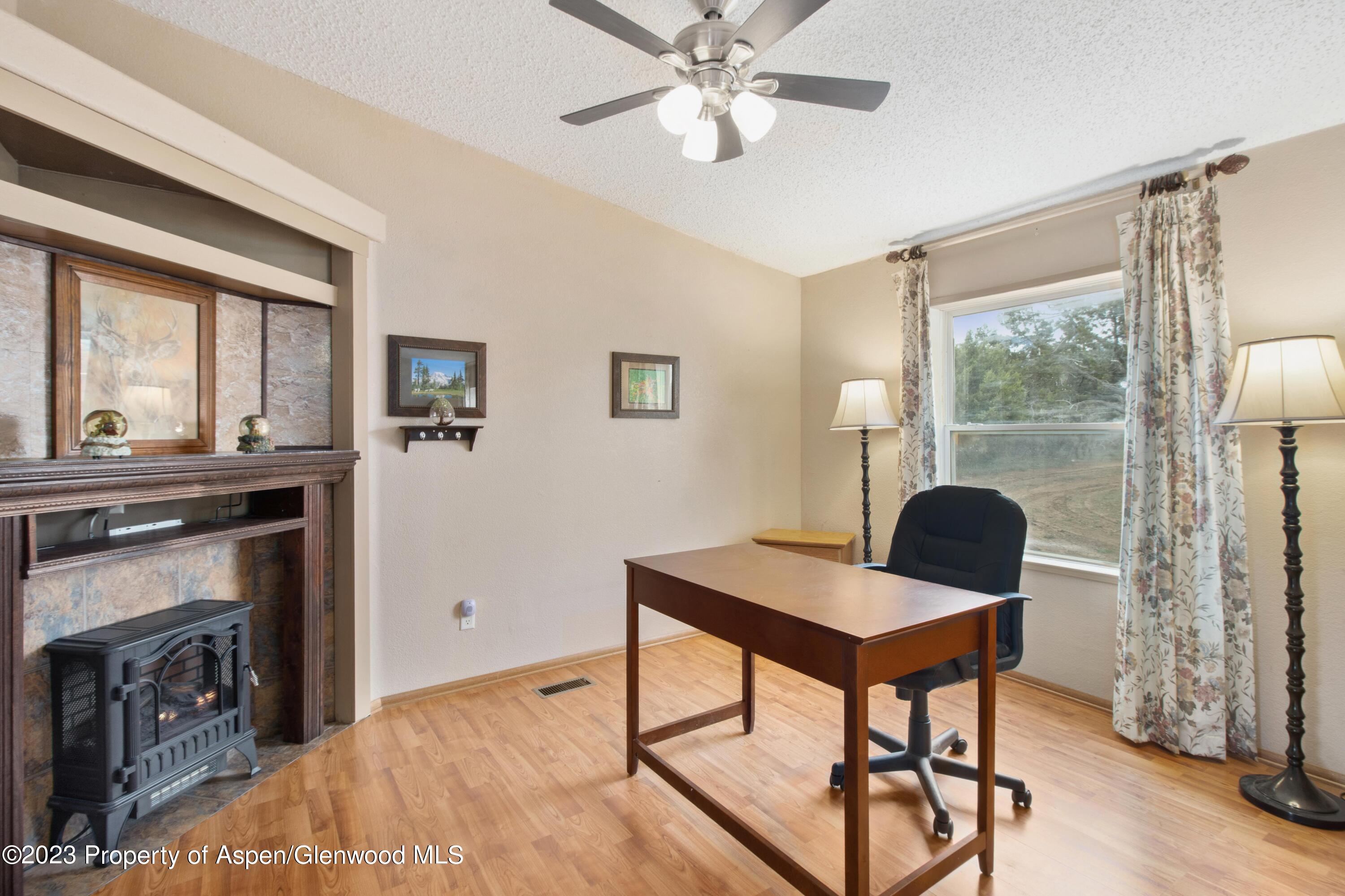 2345 County Road 306 Parachute, CO 81635 - Photo 7 of 29 a workspace with furniture and chandelier
