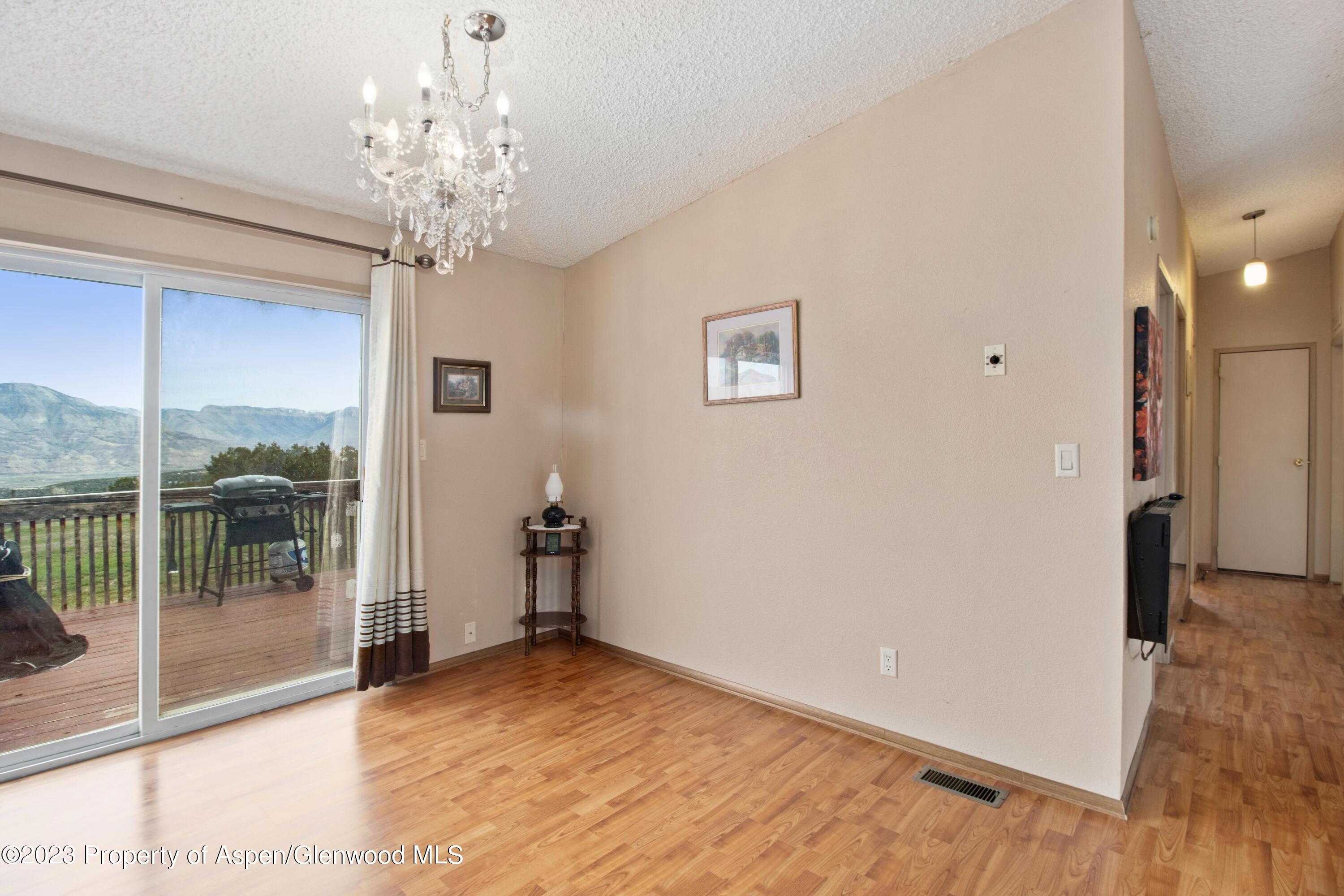 2345 County Road 306 Parachute, CO 81635 - Photo 8 of 29 a view of a livingroom with a ceiling fan window and outdoor view